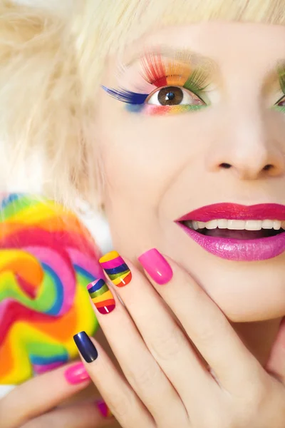 Rainbow manicure and makeup.