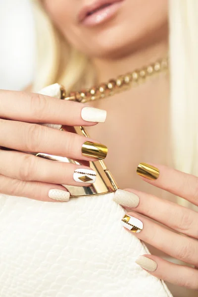 Gold manicure with rhinestones.