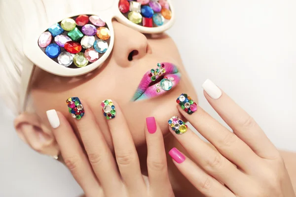 Makeup and manicure with crystals.