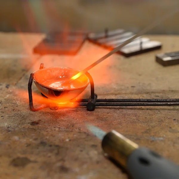 Jeweler melts precious metal