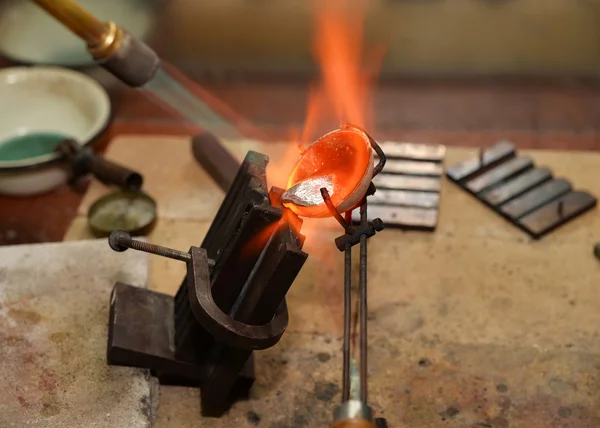 Jeweler melts precious metal