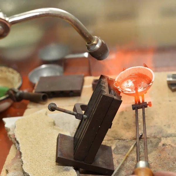 Jeweler melts precious metal