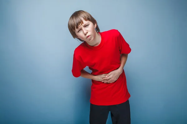 Boy teenager twelve years in the red shirt abdominal pain, gastr