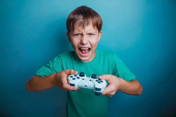 Teen boy screaming open mouth holds the emotions game joystick o