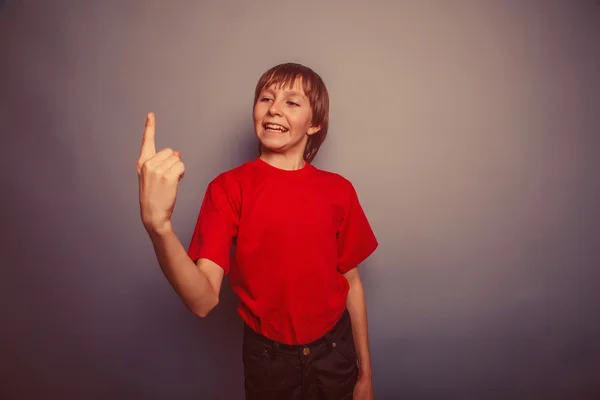 European-looking boy of ten years shows number one finger on a g