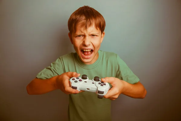 Teen boy screaming open mouth holds the emotions game joystick o