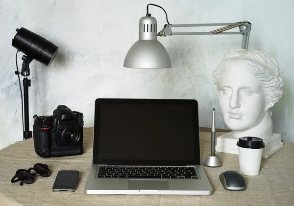 Workplace freelance photographer . Tool Set Photographer : laptop, camera , head, pen, phone, mouse, glasses.