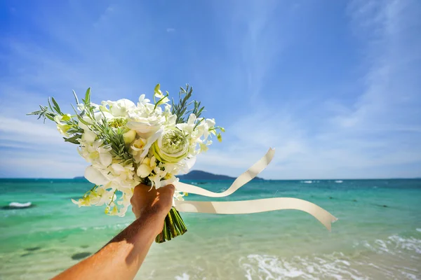 Wedding bouquet of white flowers in hand