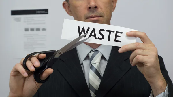 Businessman Cuts Waste Concept