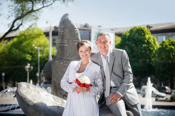 Groom and bride near the fountain
