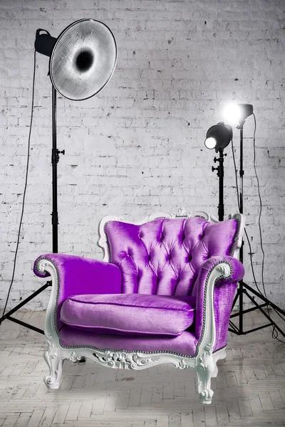 Photographic studio with  accessories and violet armchair