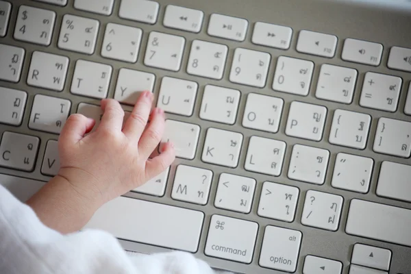 Close-up of a Baby's Hand Using Keyboard