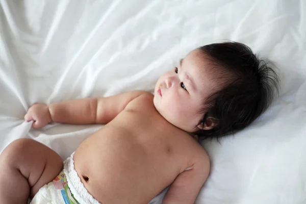 Portrait of Newborn baby Lying Down on a Bed, Top View