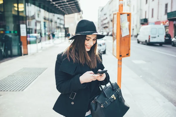 Woman waiting at the bus stop