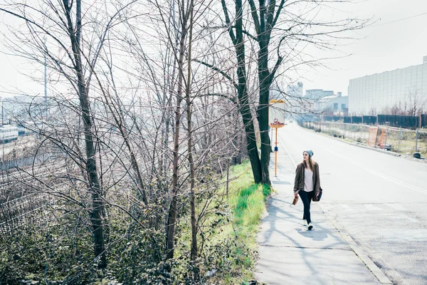 Hipster woman strolling in the city