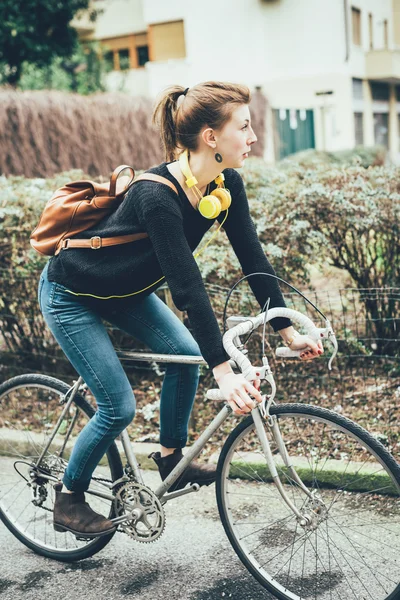 Sporty blonde woman riding a bike
