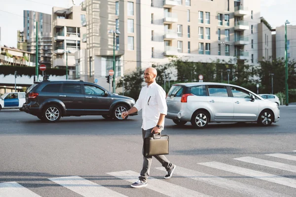 Business man walking on pedestrian crossing