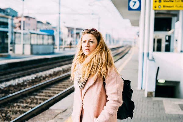 blonde woman at the train station