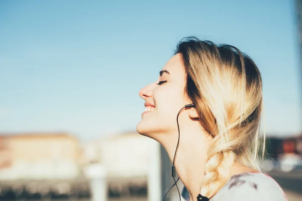 Woman listening music with earphones