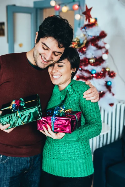 Man and woman couple holding gifts