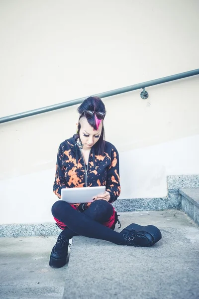 Young beautiful punk dark girl using tablet