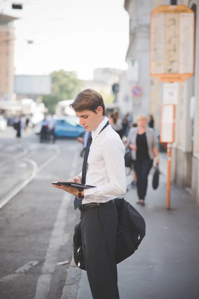 Young handsome elegant blonde model man using tablet