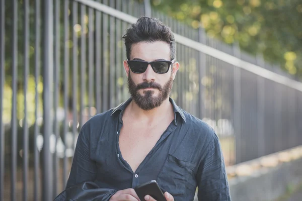 Bearded man using smartphone