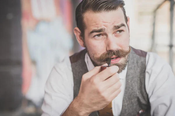 Man with big moustache smoking pipe