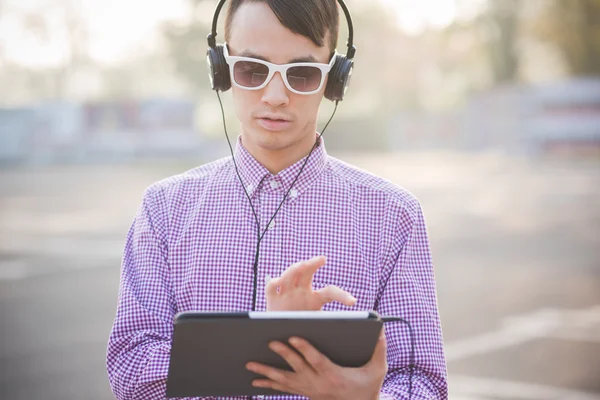 Man with tablet and headphones
