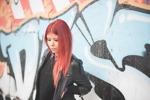 Young woman against Graffiti wall