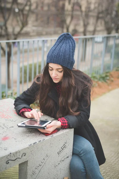 Young woman with tablet in city