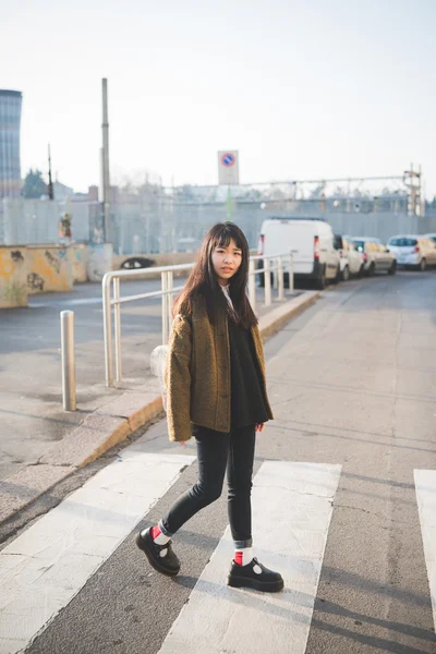 Asian woman crossing street