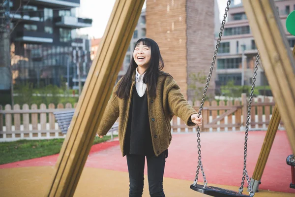 Young asian woman near swing