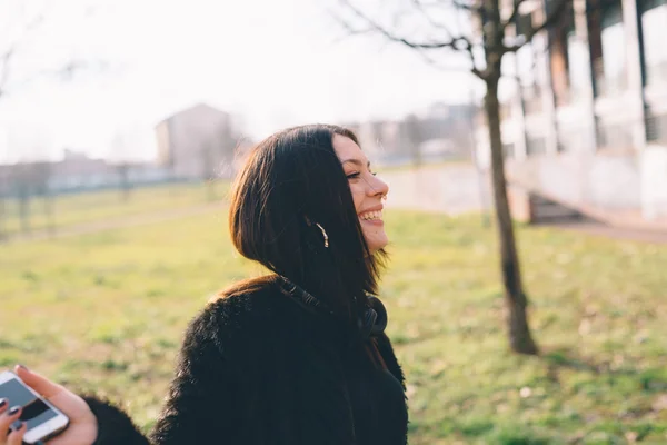 Young girl in park with headphones