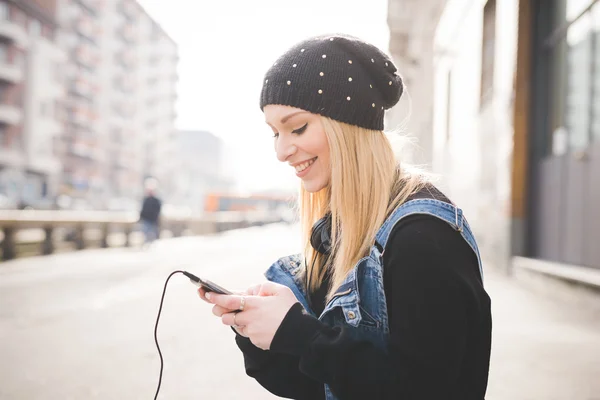 Beautiful woman in city with smartphone