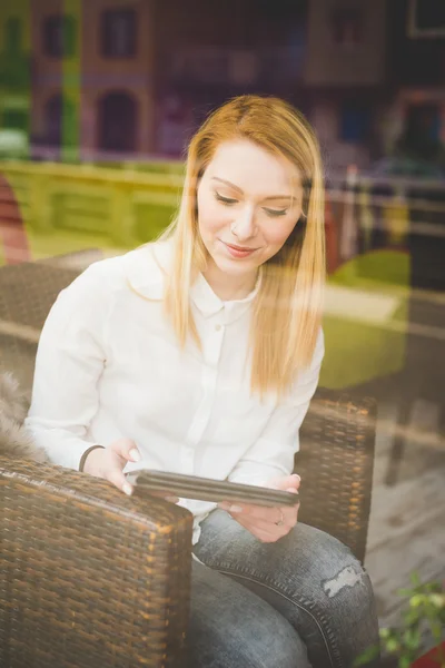 Beautiful woman in restaurant using tablet