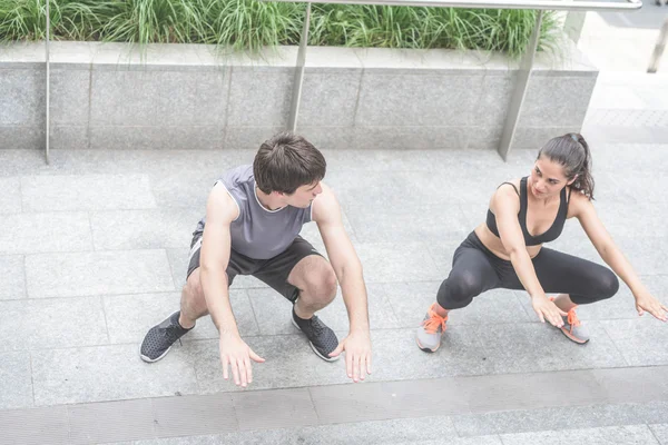 Man and woman doing squat