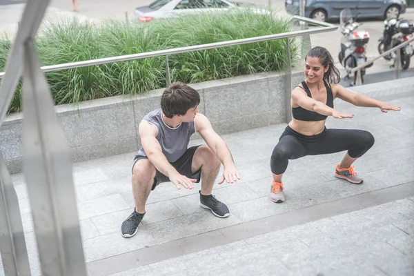 Young handsome sportive man and woman