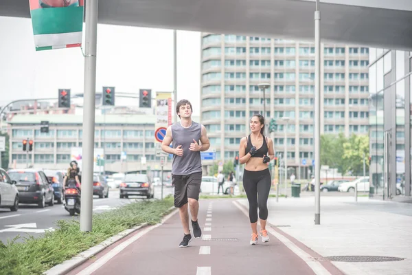 Caucasian man and woman running