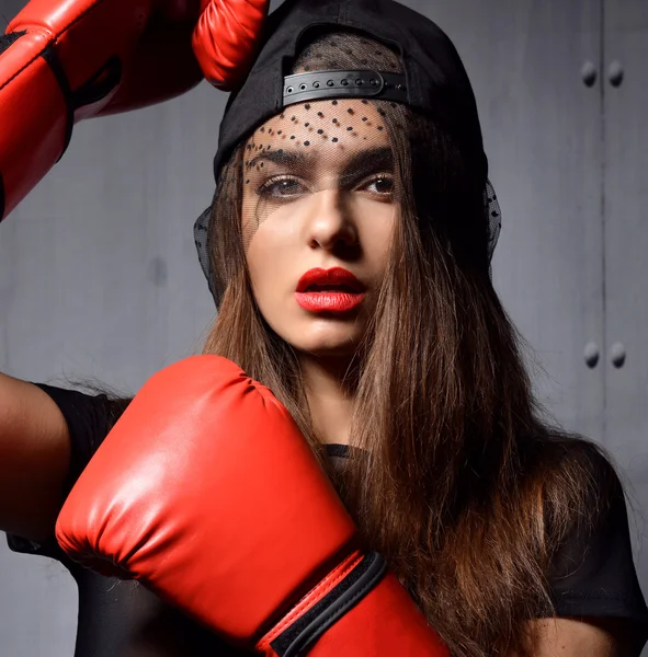 Sexy woman with red Boxing Gloves at the gym concept about sport