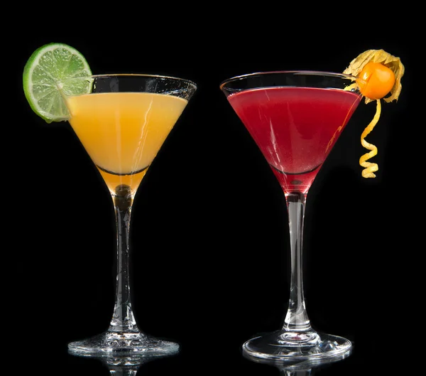Two cocktails cosmopolitan cocktails decorated with citrus lemon