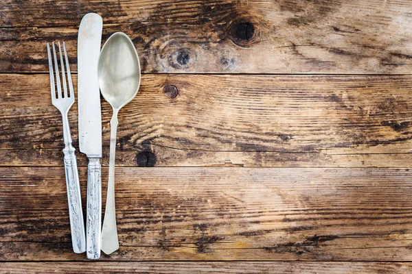 Old knife, spoon and fork decoratively presented.