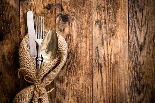 Flatware the old wooden table with a rustic style.
