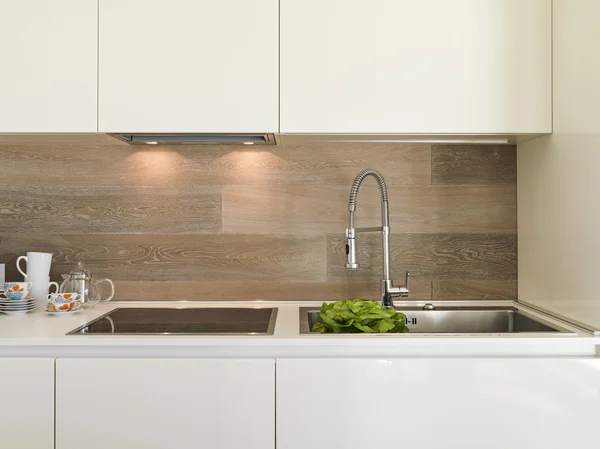 Detail of steel faucet in a modern kitchen