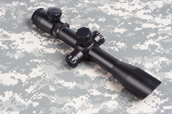 Sniper scope on camouflage