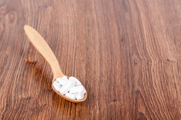 Wooden spoon with pills