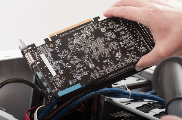 Male hands cleaning the video card