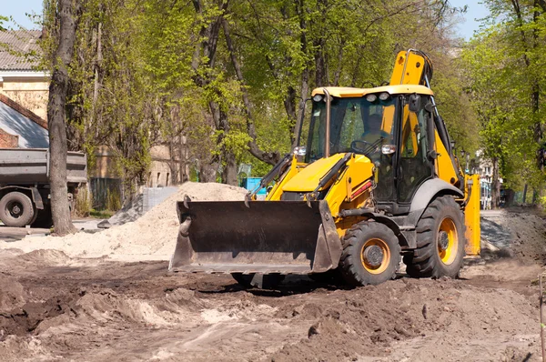 Excavator works with earth