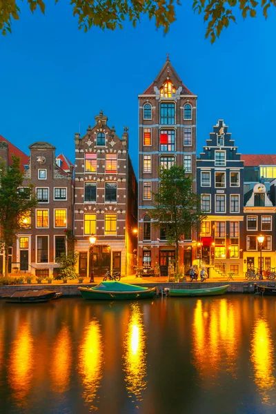 Night city view of Amsterdam canal with dutch houses