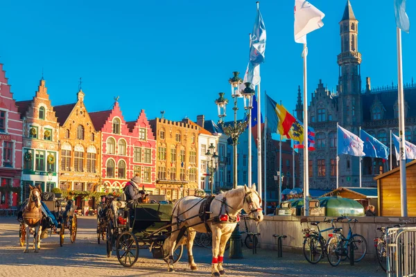 Horse carriage at Christmas morning on Markt square of Brugge